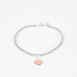 PULSERA DE CUENTAS CON INSIGNIA DE CORAZÓN ROSA