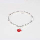 PULSERA DE CUENTAS CON INSIGNIA DE CORAZÓN ROJO